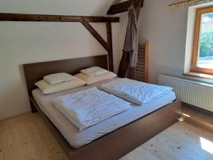1 dormitorio con 1 cama con 2 almohadas en Vila Hedvika en Nové Hrady