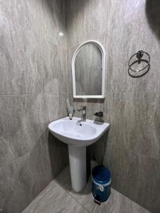 a bathroom with a white sink and a mirror at Kada Suites in Riyadh