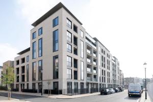 a large white building on a street with cars parked at Urban Chic - Portobello in London