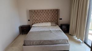 a bedroom with a bed and two night stands at Bright Casablanca Apt in Casablanca