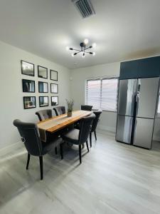 a dining room with a table and a refrigerator at Retreat near Kaseya Center Calle Ocho Downtown Miami Beaches in Miami