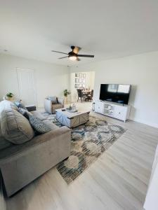 a living room with a couch and a flat screen tv at Retreat near Kaseya Center Calle Ocho Downtown Miami Beaches in Miami