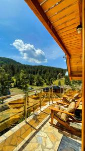 a deck with benches and a view of a river at Star Villas Žabljak in Borje