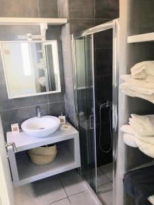 a bathroom with a sink and a shower and a mirror at Quiet 2-bedroom sea view villa with shared pool in Mármara