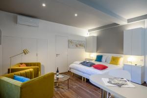 a hotel room with a bed and a table and chairs at Activinum in Givry