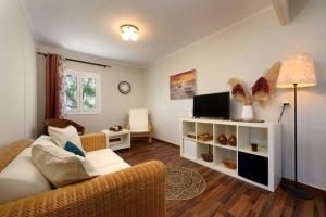 a living room with a couch and a tv at Traditional Seaview Home Candili in Corfu Town