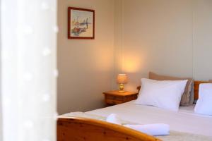 a bedroom with a bed and a table with a lamp at Traditional Seaview Home Candili in Corfu Town