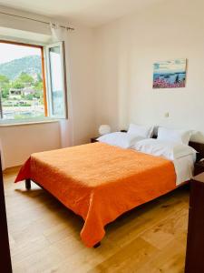 a bedroom with two beds and a large window at Apartments Lukrecia in Hvar