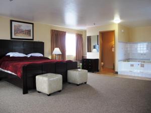 um quarto de hotel com uma cama e uma banheira em Merrill Field Inn em Anchorage