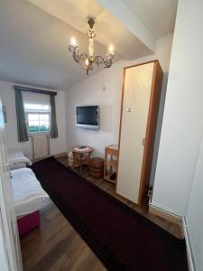 a room with a bedroom with a bed and a chandelier at Guesthouse Yildiz in Sarajevo