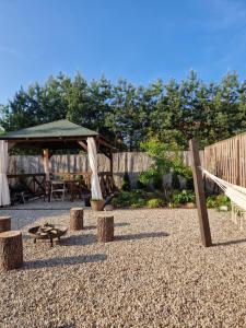 a playground with a pavilion and swings and trees at Apartamenty Zielone Drzwi in Kruklanki