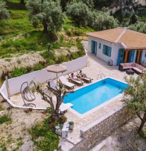 a villa with a swimming pool and a house at Meliades villas in Apolpaina