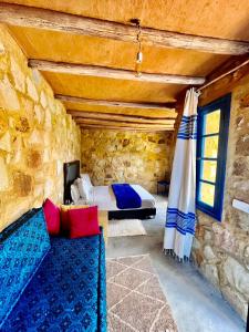 a bedroom with a bed and a couch in a room at Dmina House in Asilah