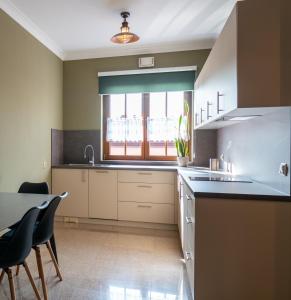 a kitchen with a sink and a table with chairs at APARTAMENT Piłsudskiego13 Chrzanów in Chrzanów +8 photos