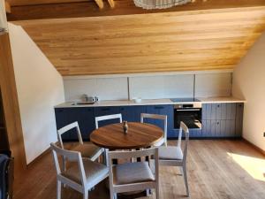 a kitchen with a wooden table and chairs at Dodoši Ksenija in Cetinje