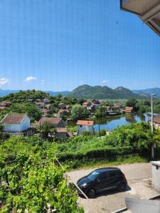 a car parked in a parking lot next to a body of water at Dodoši Ksenija in Cetinje