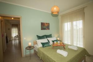 a bedroom with a large bed with a table on it at Potamos Luxury Apartment in Epanomi
