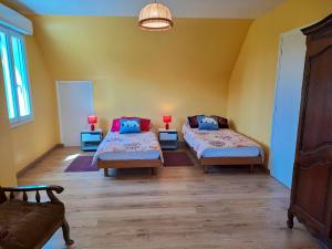 a room with two beds and a couch in it at Maison de 3 chambres avec jardin amenage et wifi a Saint Alban a 3 km de la plage in Saint-Alban