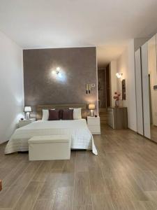 a large bedroom with a large bed and wooden floors at La Taverna dei Tre Micetti in Villafranca di Verona