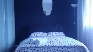 a blue bedroom with a bed with white sheets at Apartman Anastasija in Banja Luka