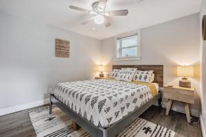 a bedroom with a bed and a ceiling fan at The Urban Nest in Tampa