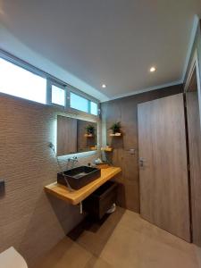 a bathroom with a sink and a mirror at New minimal apartment,10' from Athens airport in Spata