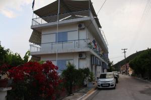 a building with a car parked in front of it at Melissani hotel in Sami