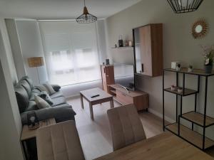 a living room with a couch and a table at Apartamentos aguanaz in Entrambasaguas