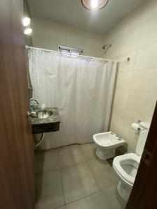 a bathroom with a toilet and a sink at La niña in San Juan