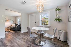 a dining room and living room with a table and chairs at The Urban Nest in Tampa