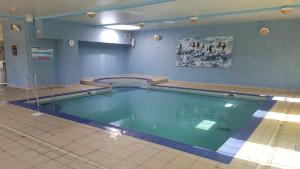 a large swimming pool in a building at Chalet nature proche lac et à 20 mn des plages en Vendée in La Chapelle-Hermier