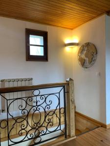 a room with a staircase with a window and a clock at Chez Camille aux Sieges in Les Rives +24 photos