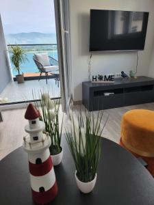 a living room with a table with a lighthouse on it at Feel Good View in Trogir