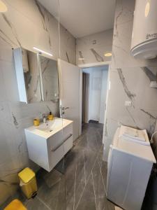 a bathroom with a white sink and a mirror at Feel Good View in Trogir +26 photos