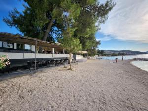 a beach with tables and chairs on a sandy beach at Feel Good View in Trogir