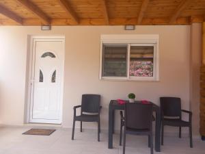 a table and chairs in a room with a window at Kolymbia summer holidays in Kolymbia