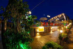 a building with lights on it at night at Jasmine Hotel & Apartments in Agios Stefanos