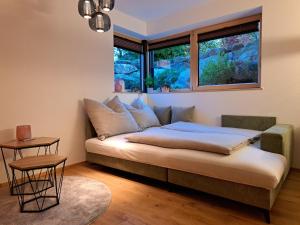 a bed in a room with a window at Ferienwohnung Alpenglück hoch3 in Oy-Mittelberg +23 photos