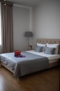 a bedroom with a large bed with a red laptop on it at Hotel DENINNA in Vinnytsya