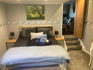 a bedroom with a bed with a stuffed animal on it at The Spinney lodge in Bubbenhall