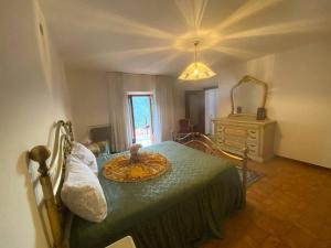 a bedroom with a bed with a table and a dresser at Casa vacanze il pettirosso. in Pisogne