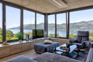 a living room with a view of the water and mountains at Villa Soul Sisters in Korčula