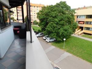 a balcony with cars parked in a parking lot at Apartment Mateo in Maribor