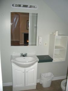 a white bathroom with a sink and a mirror at The View Lodgings in Princeton