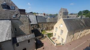 an aerial view of a city with buildings and a tower at appartement du croissant in Bayeux