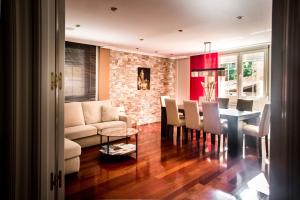 a living room and dining room with a table and chairs at Ciudad de Teruel in Teruel