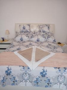 a bedroom with a bed with a blue and white bedspread at Balaton Panorama in Balatonfüred