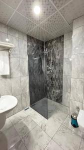 a bathroom with a shower and a sink at ATLIHAN PLUS HOTEL in Doğubayazıt