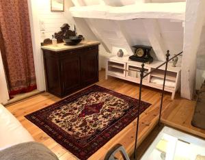 a room with a bed and a rug on the floor at La Lotoise gîte au Coeur De Saint-Cirq-Lapopie in Saint-Cirq-Lapopie