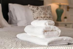 a stack of towels sitting on a bed at Seaview Oasis - Margate Abode - Sleeps 4 in Kent